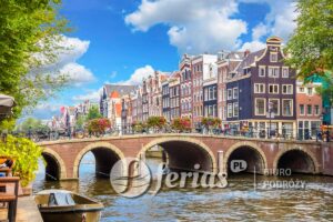 Amsterdam downtown - Amstel river, old houses and a bridge. Nice view of the famous city of Amsterdam. Travel to Europe. Amsterdam, Holland, Netherlands, Europe.