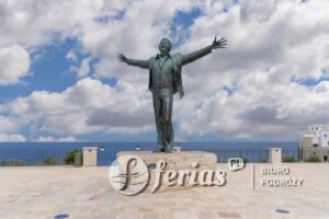 Polignano a Mare, Italy, Apulia - May 24, 2024: Monument to italian musician Domenico Modugno (Monumento a Domenico Modugno), located on a square by the sea nearby Lama Monachile beach