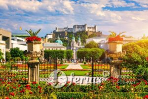 Beautiful view of famous Mirabell Gardens with the old historic Fortress Hohensalzburg in the background in Salzburg, Austria. Famous Mirabell Gardens with historic Fortress in Salzburg, Austria.